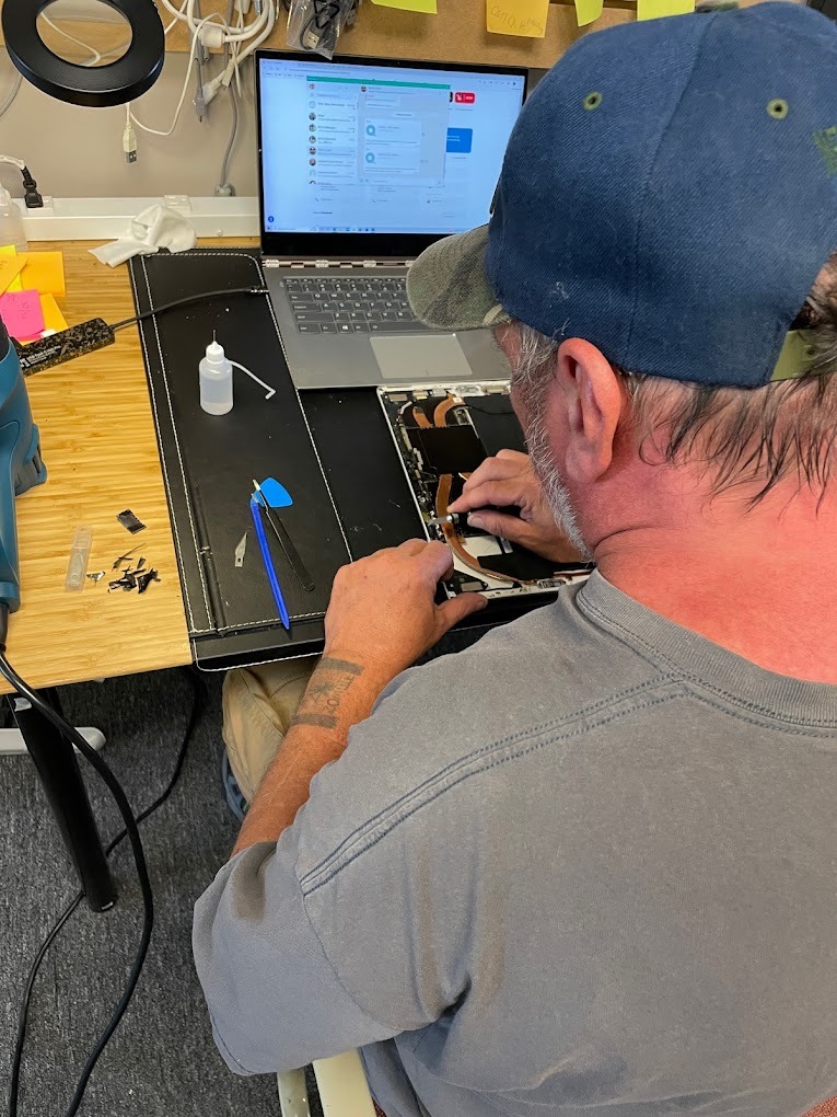 Mr Fix technician performing water damage repair and data recovery on an iPhone