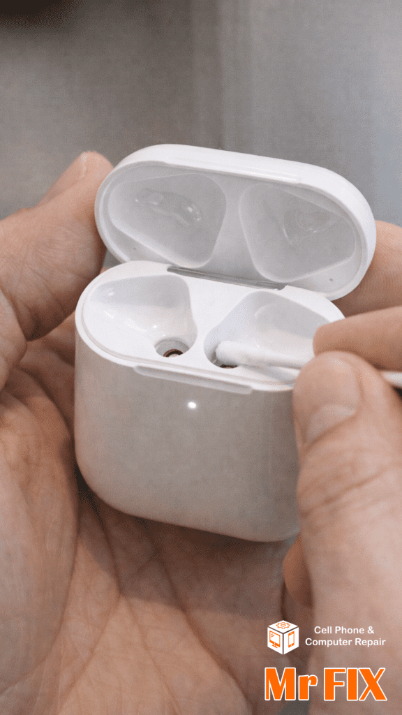 Instructional close-up: Cleaning AirPods charging contacts inside the case with a Q-tip swab